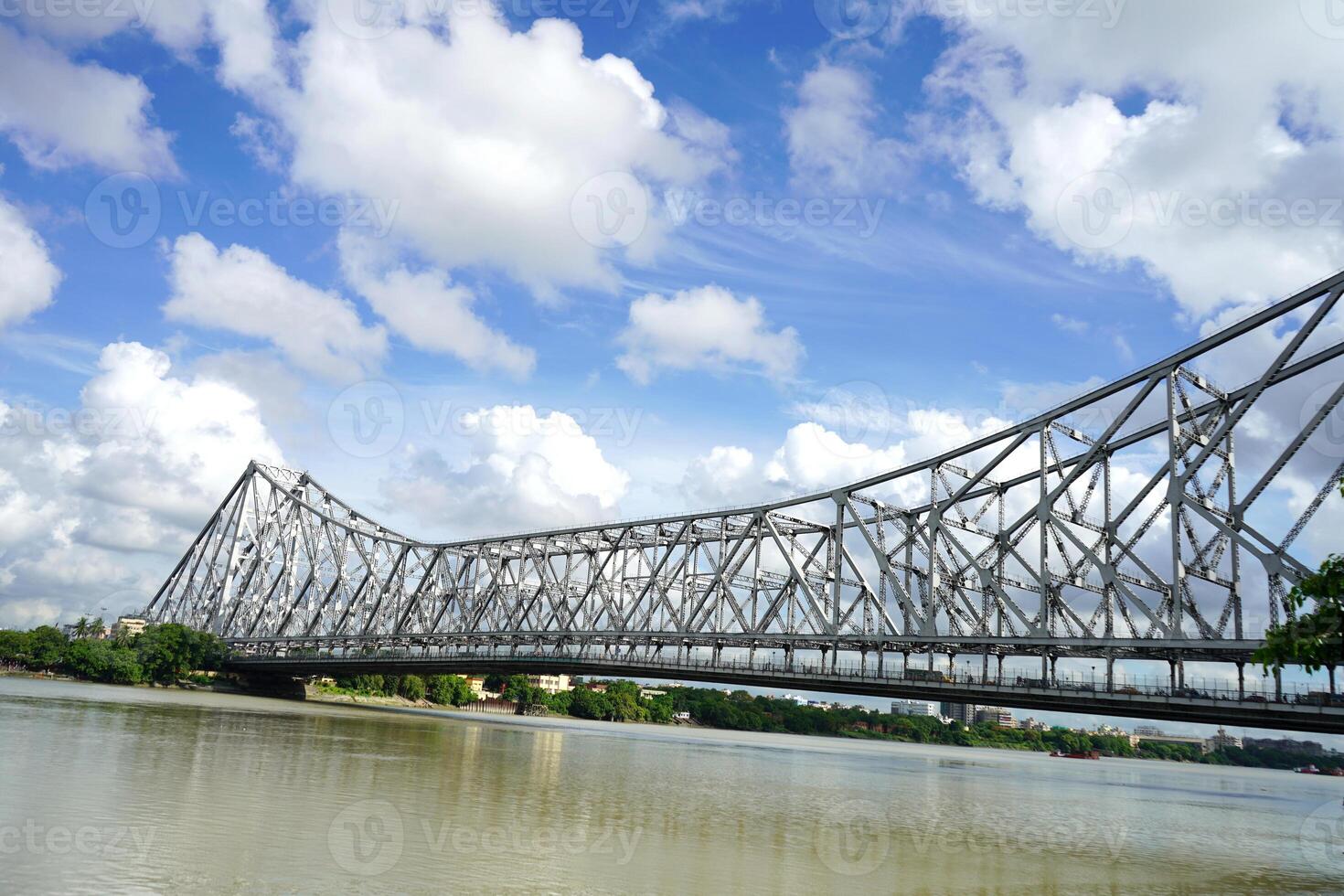 The historic Howrah bridge from Mullick Ghat in sunny weather photo