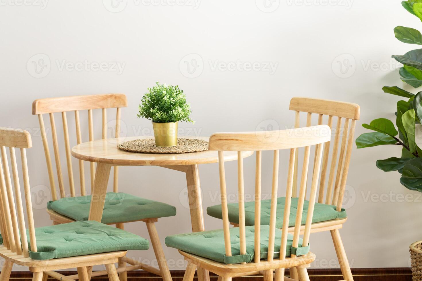 The wooden chairs and tables have the green color from the little trees. photo