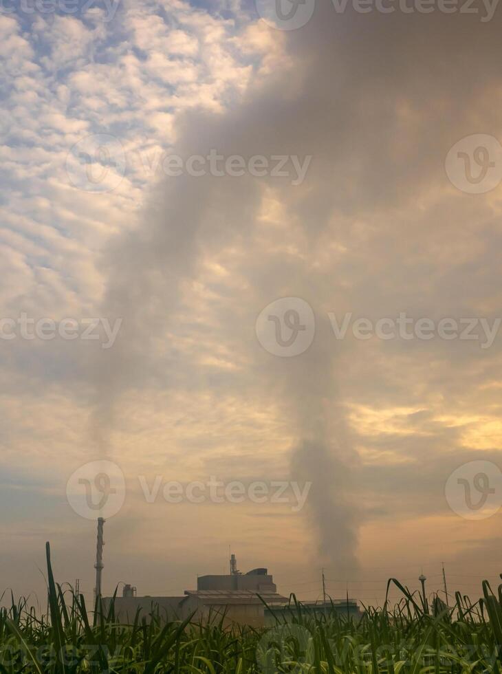 Smoke from the boiler stack and the vapor from a cooling tower in the power plant photo