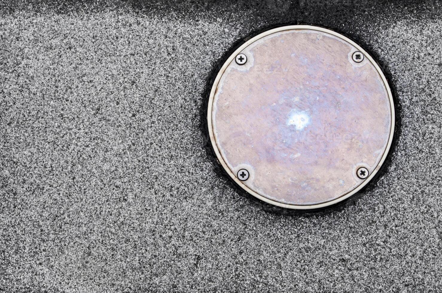 The surface texture on the non slip flooring and the metal cover of service hole beside the pool photo