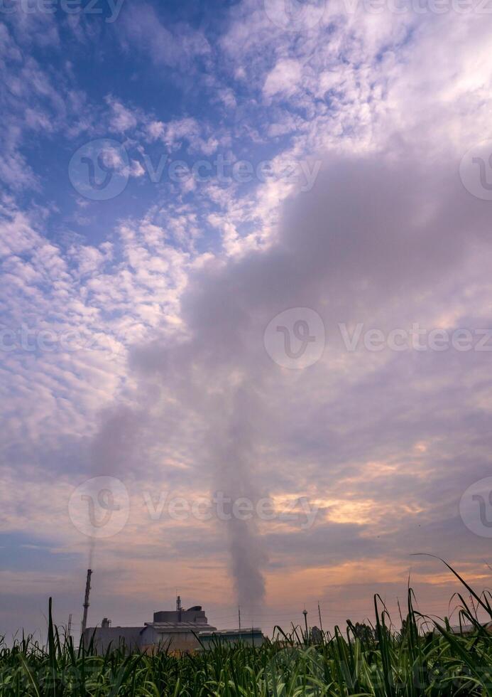 Smoke from the boiler stack and the vapor from a cooling tower in the power plant photo