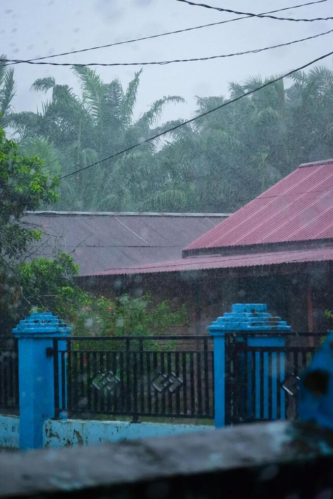 The atmosphere of a house roof being drenched in rain is suitable as a background photo