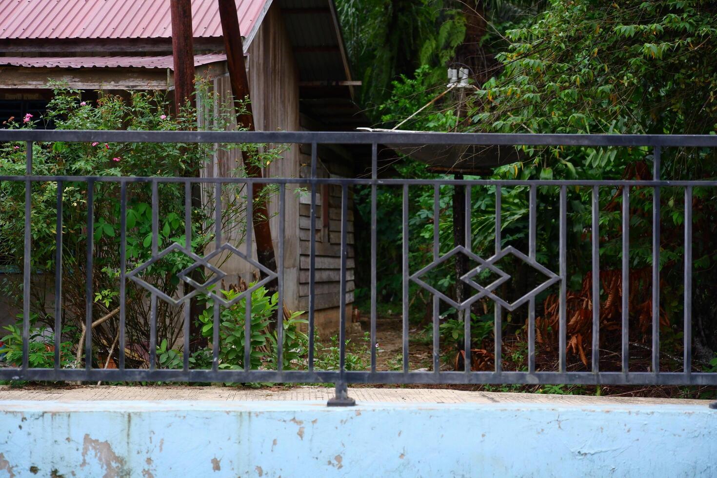 photography of iron fence and rusty damaged walls photo