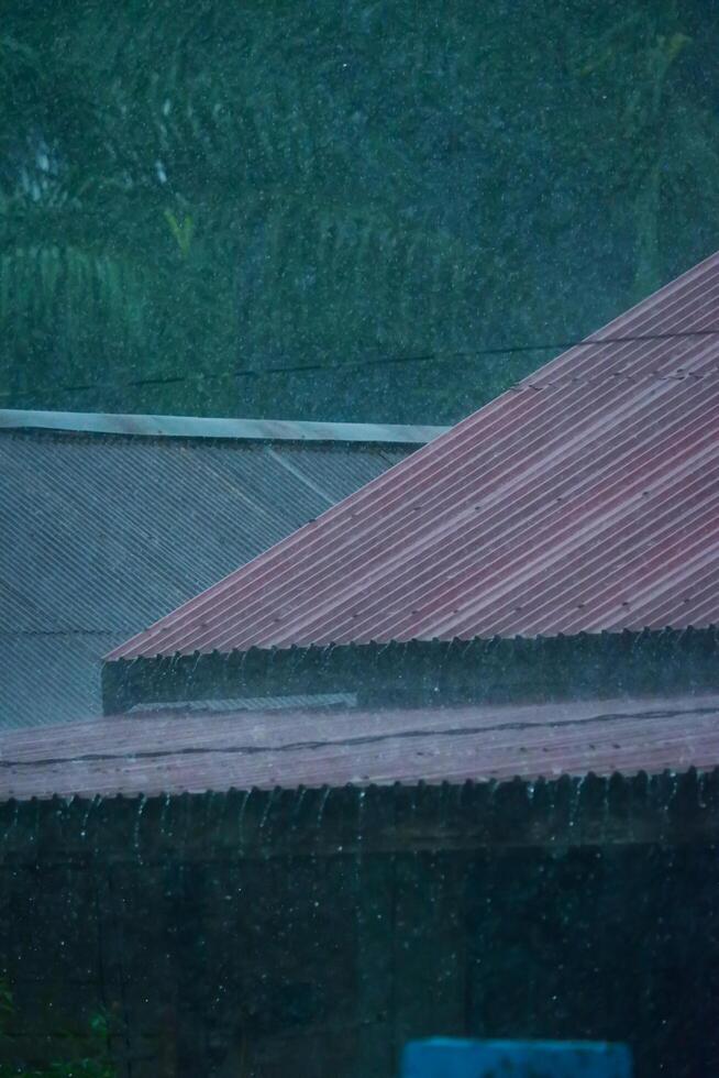 The atmosphere of a house roof being drenched in rain is suitable as a background photo