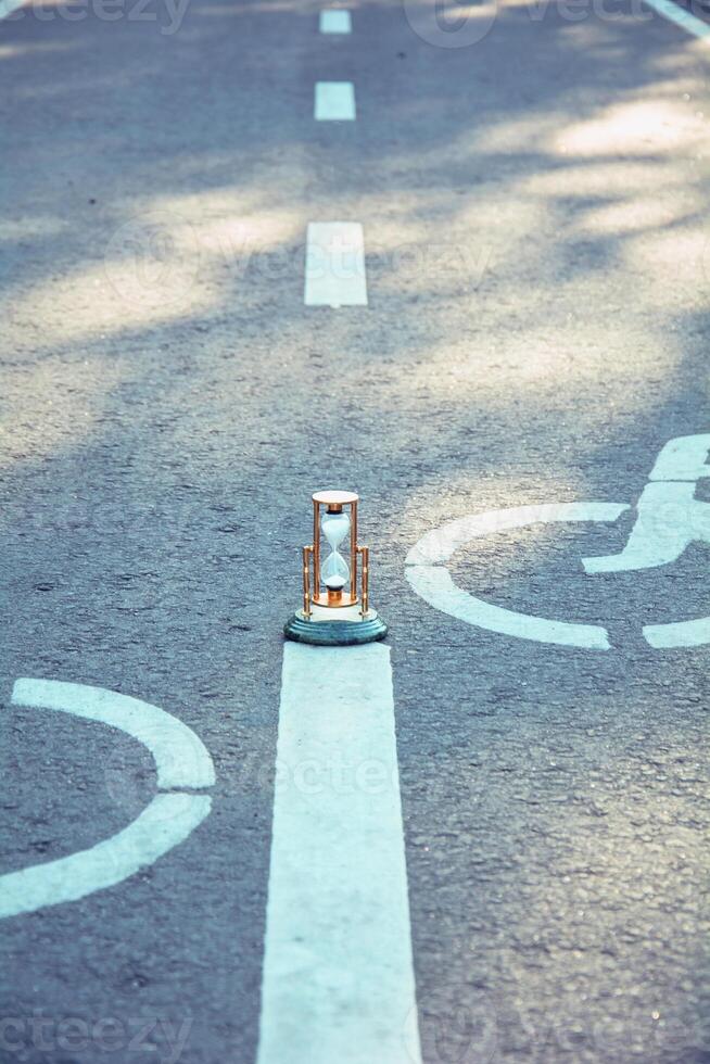 A small clock sitting on the side of a road photo