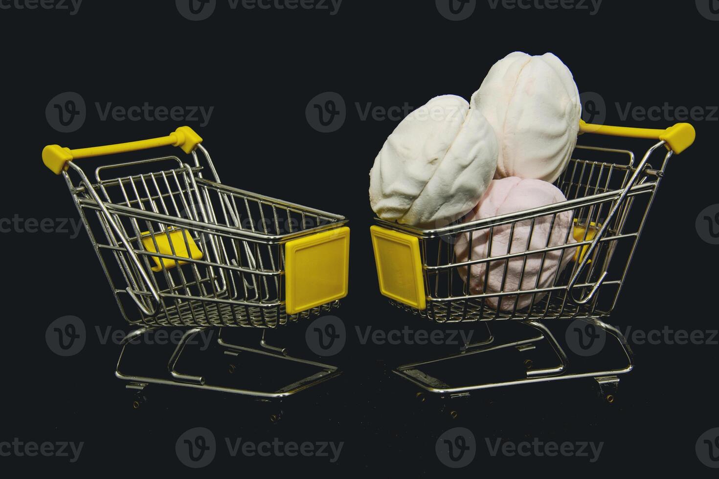 Two shopping carts filled with different types of food photo