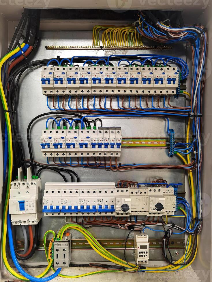 Fuse box, control panel with many various wires and fuses, electrical control panel enclosure for power and distribution electricity on the building site. photo