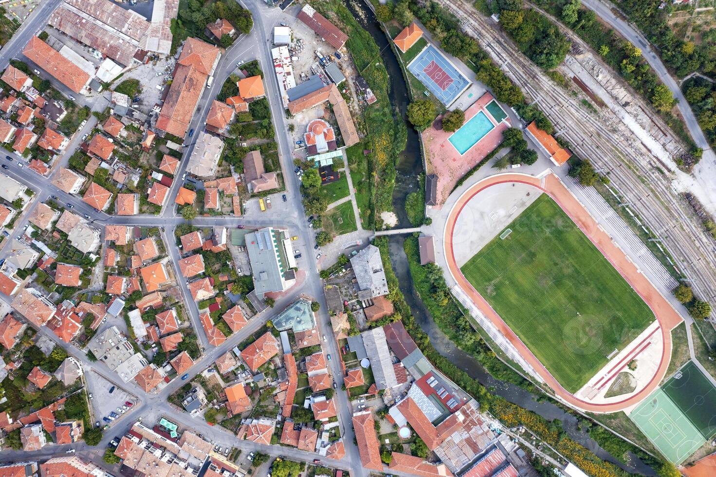 Aerial top view of the city and sports recreation fields ground, city stadium photo