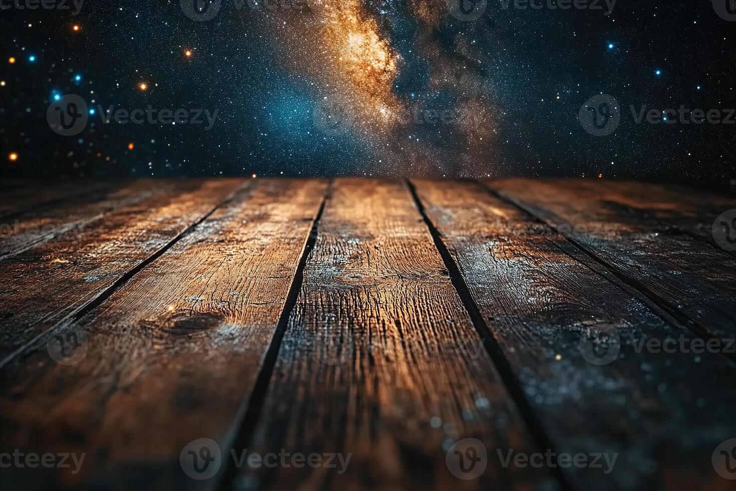 Image of old wooden table against glittering lights of starry night sky. Defocused. photo