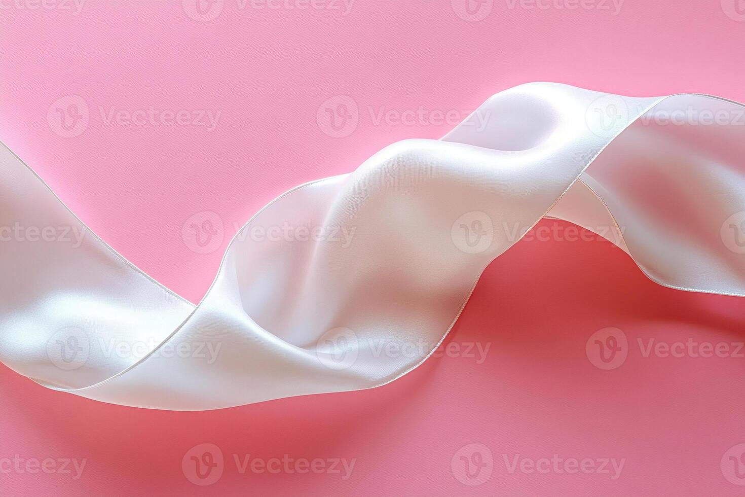 Beautiful curve of white silk ribbon on pink background. Elegant minimalistic background. photo