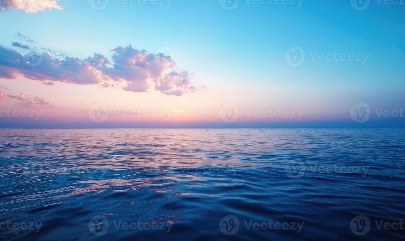 The ocean is calm and the sky is a beautiful shade of blue photo
