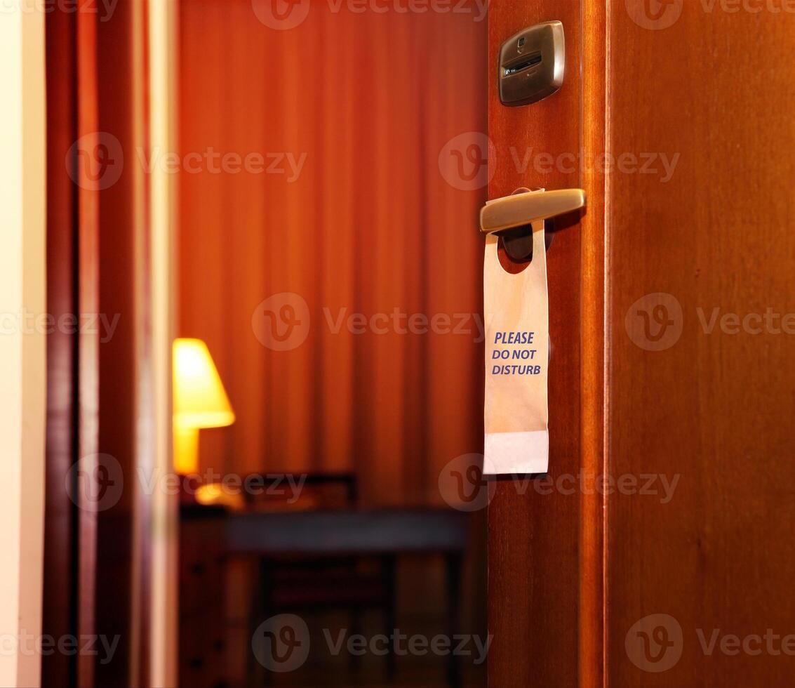 Please do not disturb sign hanging on open door photo
