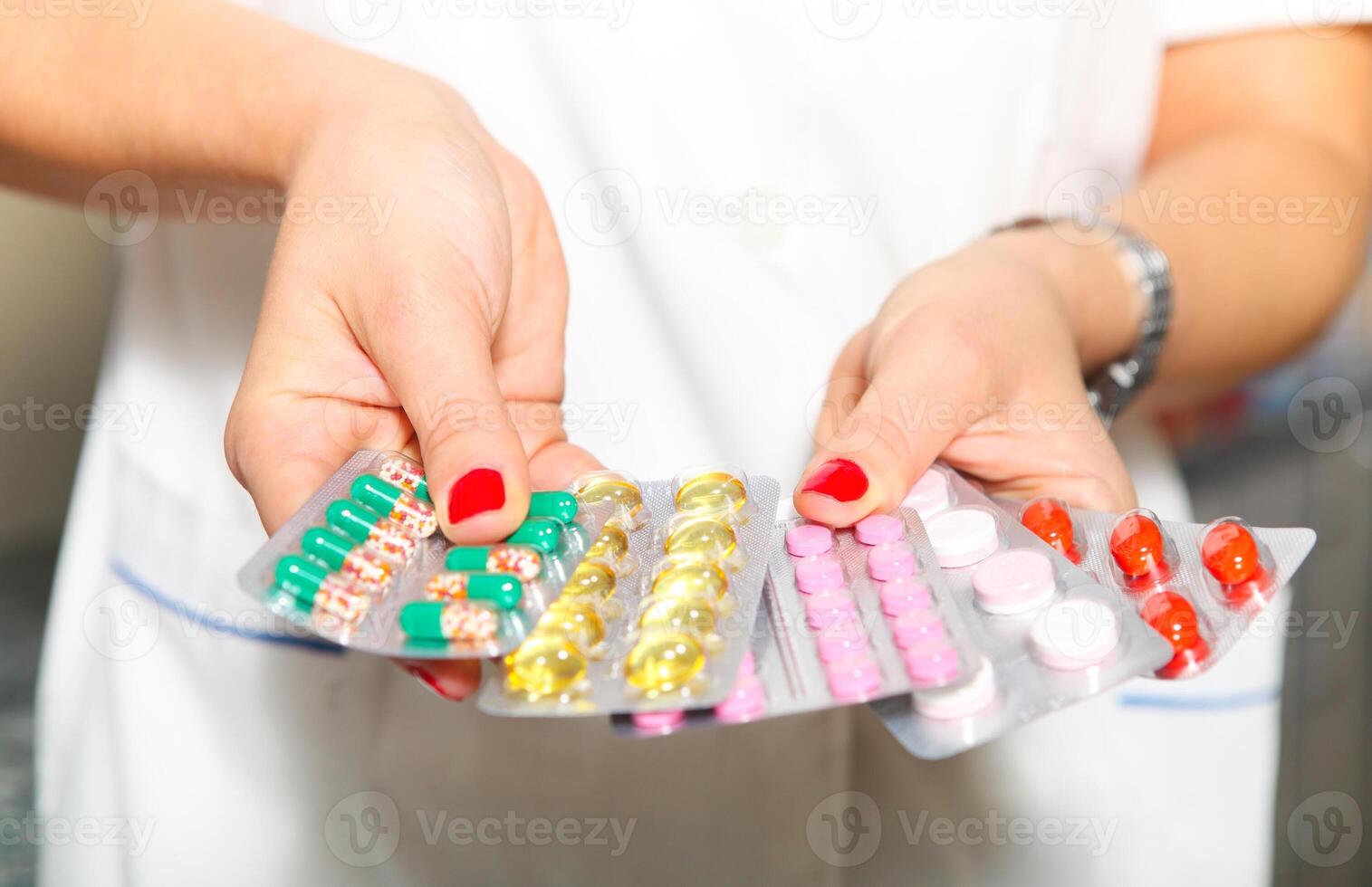 Female doctor hands holding pills photo