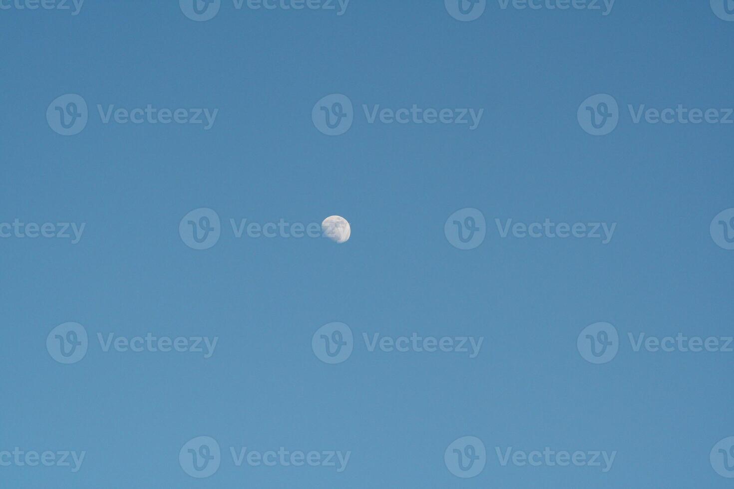 a plane flying in the sky with a moon photo