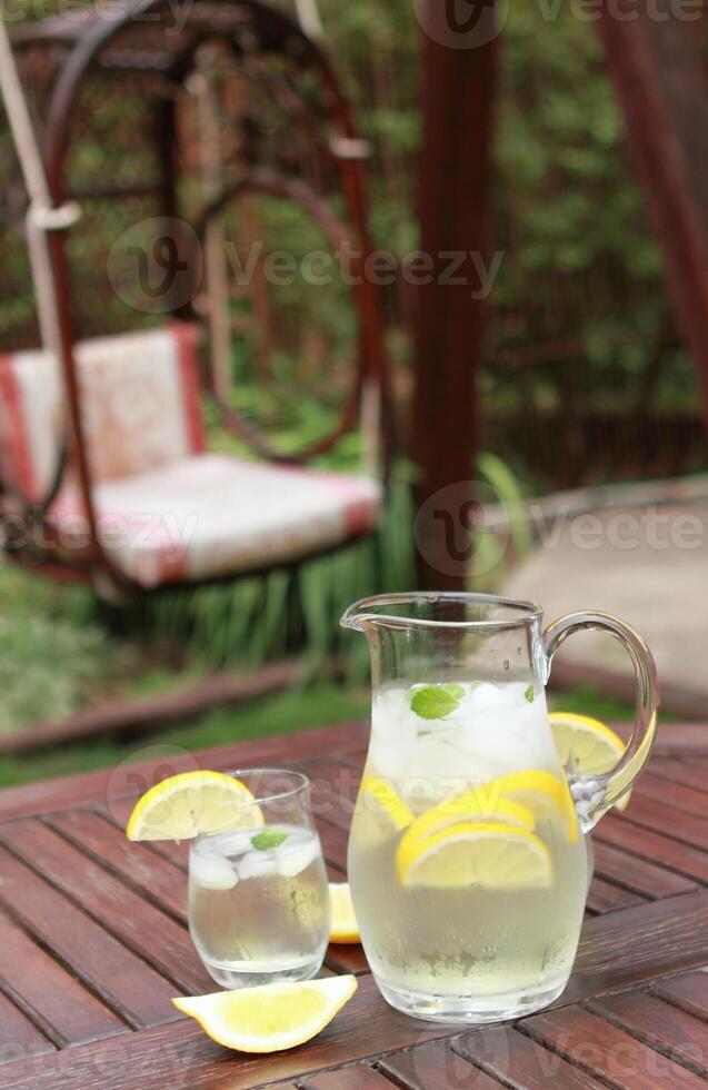 Pitcher and glasses of fresh lemonade photo
