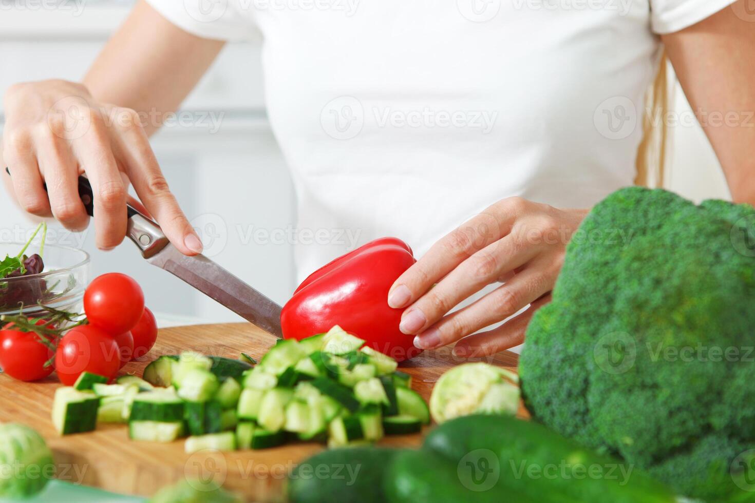 Woman's hands cutting vegetables photo