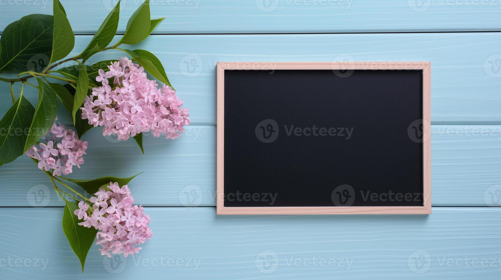 Small blackboard mockup and fresh lilac flowers. Holiday greeting card with spring blossom template advertising image. Chalkboard mock up on blue boards product photorealistic photo