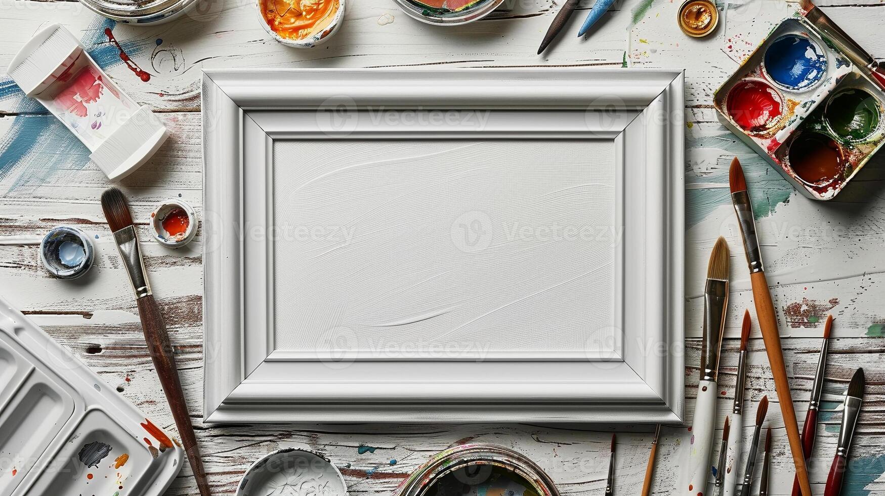 White frame mockup on rustic paint-splattered table with paintbrushes. Artist workspace photoframe template advertising image. Painter tools pictureframe border mock up photorealistic photo