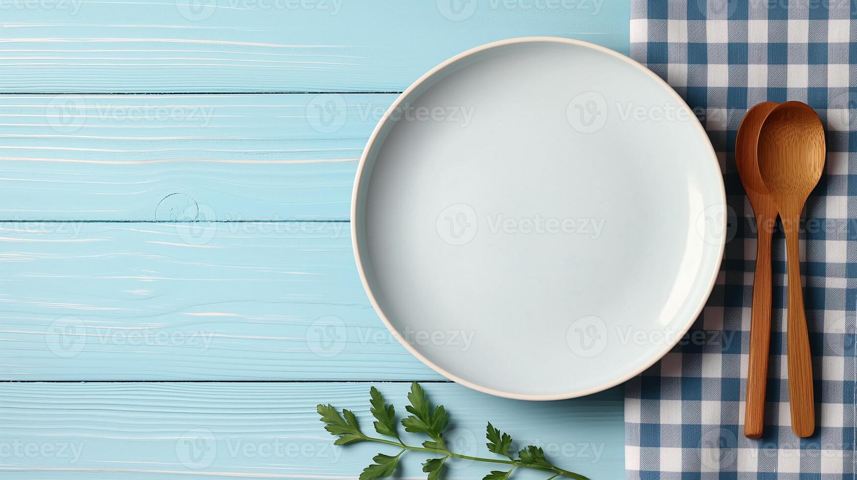 Plate with wooden spoons on blue table banner background copy space. Flatware on wooden countertop image backdrop empty. Dinner setting concept composition top view, copyspace photo