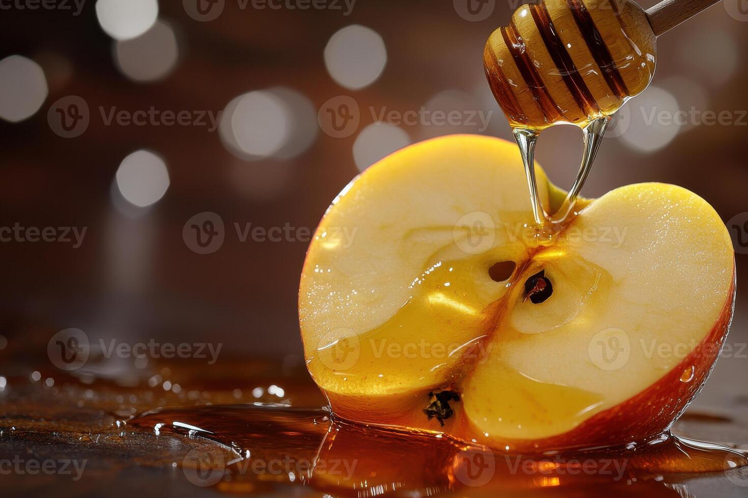 Freshly sliced apple drizzled with honey on a reflective surface decorated with bokeh lights photo