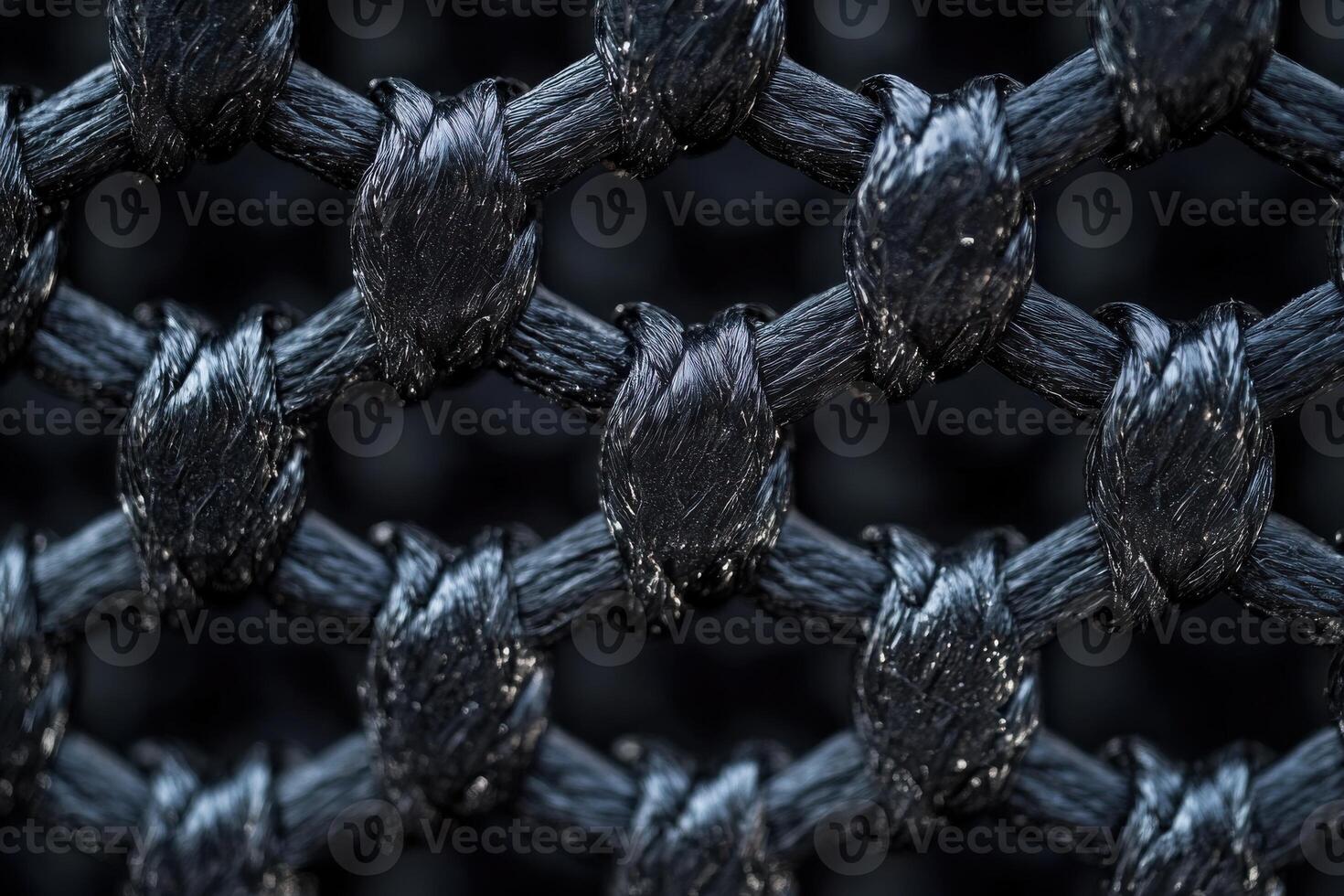 Close-up view of a textured black mesh fabric showcasing intricate woven patterns and details photo