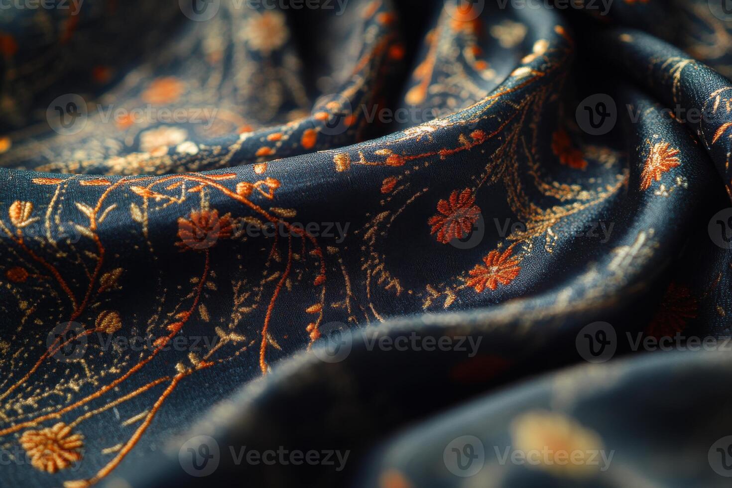 Elegant embroidered fabric with floral patterns on a dark blue background in natural light photo