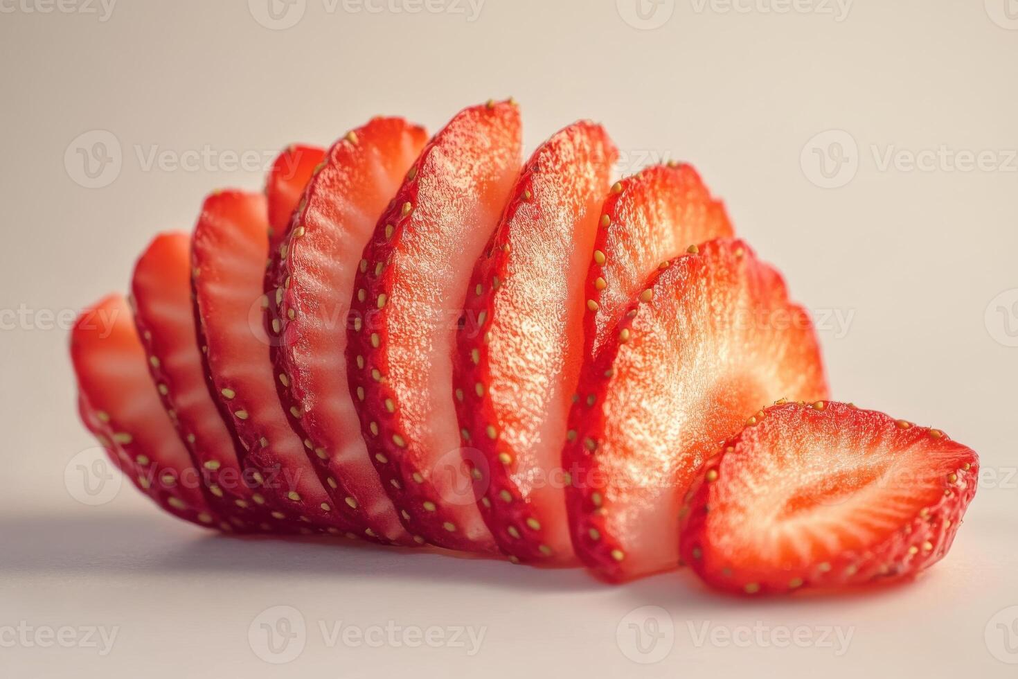 Freshly sliced strawberries arranged artistically on a light surface for a vibrant display photo