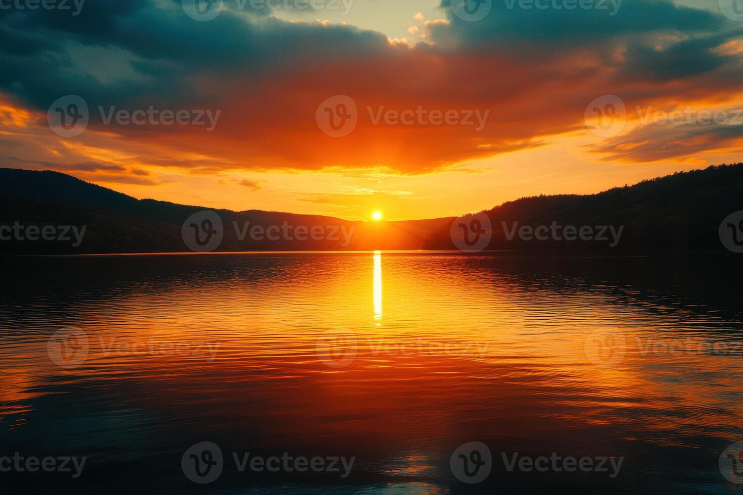 Stunning sunset reflecting on a calm lake surrounded by mountains in the evening twilight photo