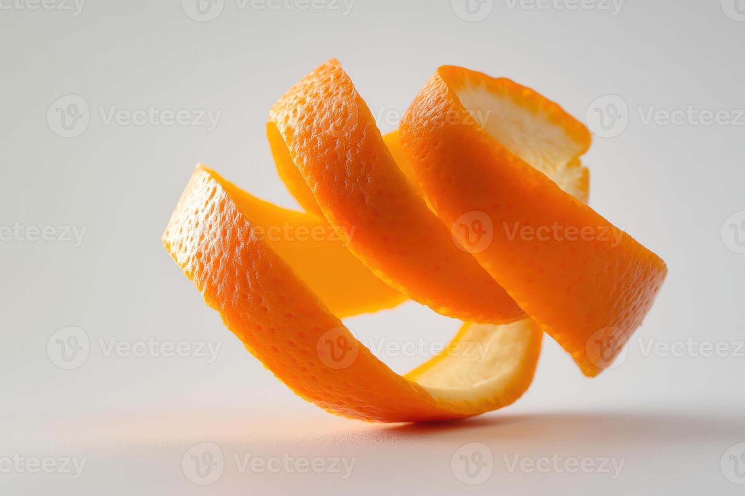 An artistic view of a twisted orange peel against a simple background in natural light photo