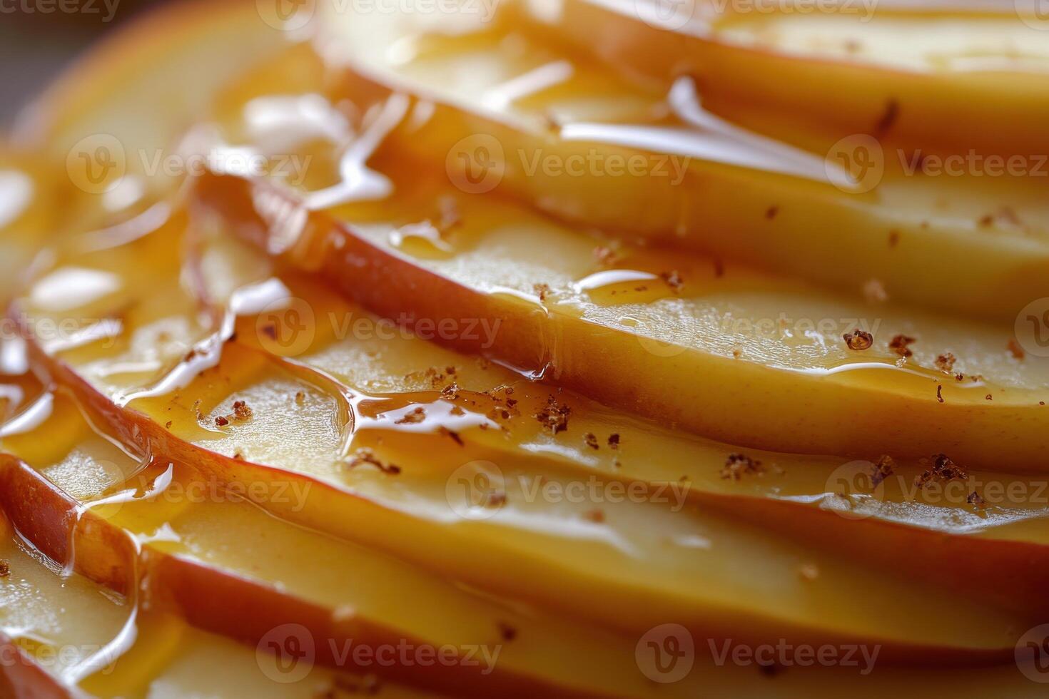 Delicious layered apple slices drizzled with sweet caramel syrup on a wooden table photo
