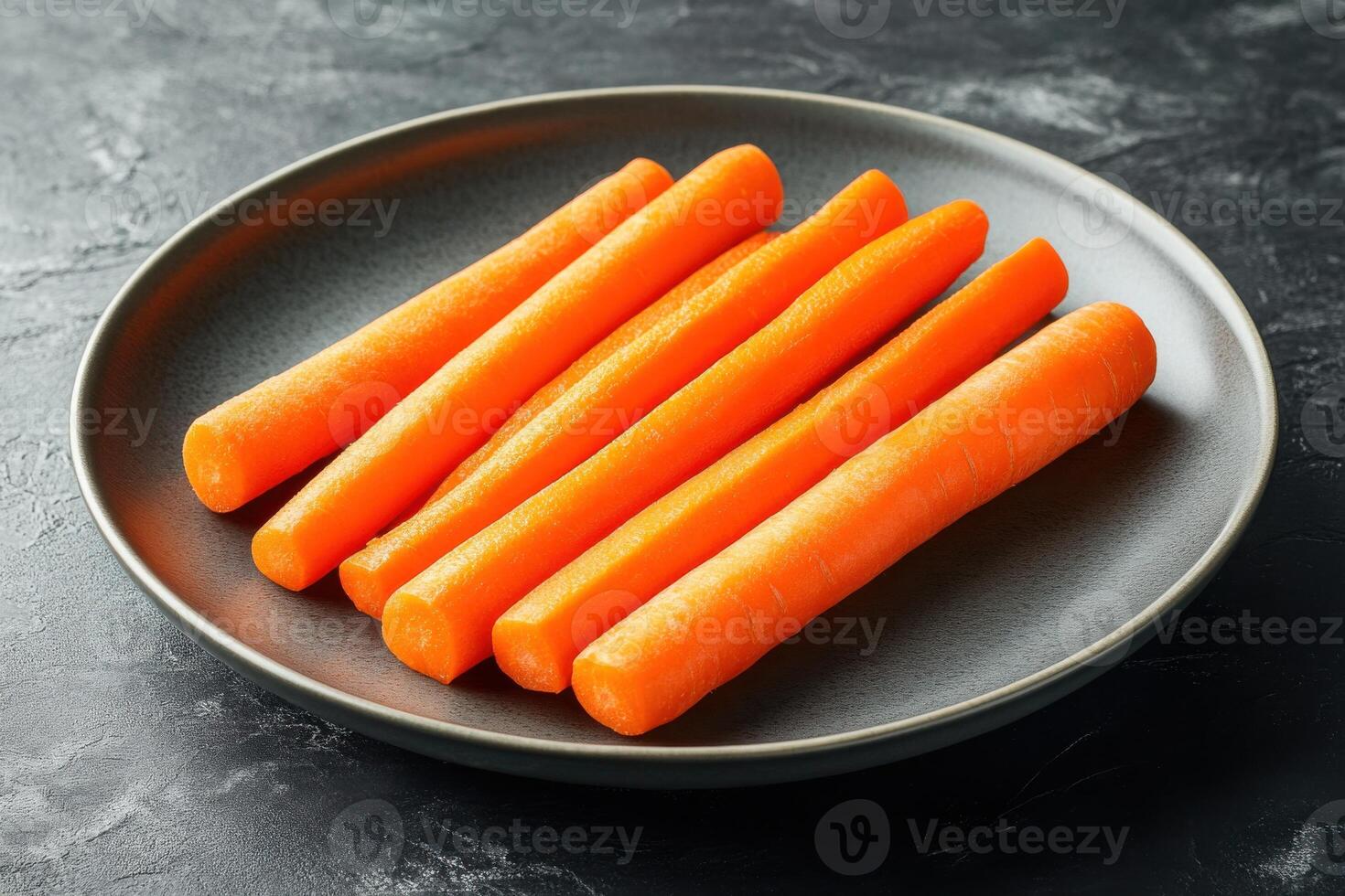 Fresh carrots neatly arranged on a dark plate in a modern kitchen setting photo