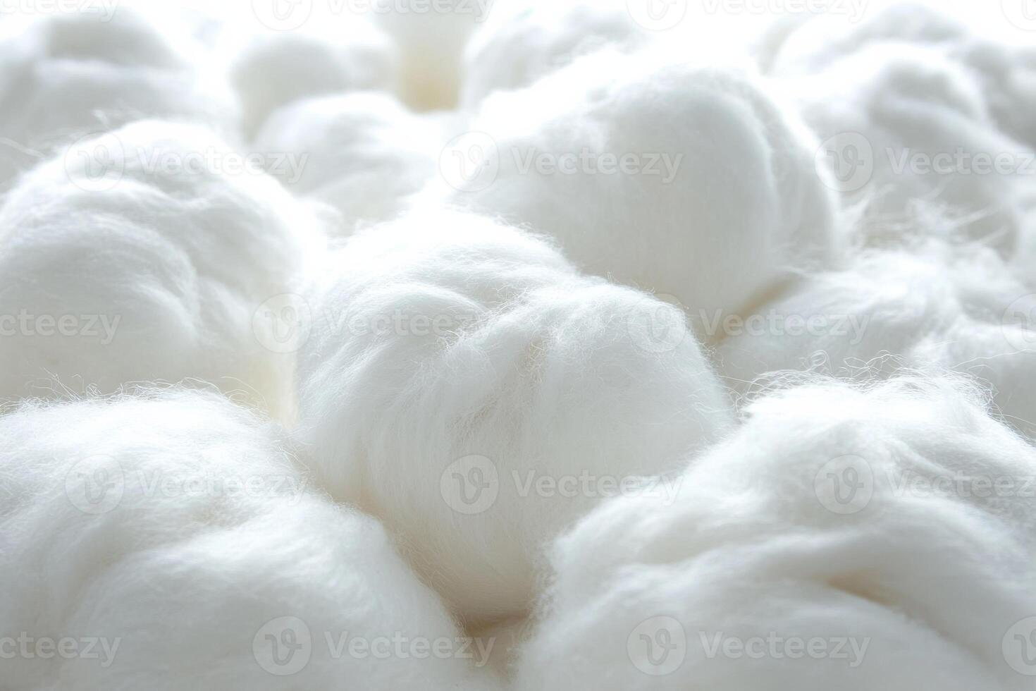 White cotton fibers arranged closely in a textile setting on a bright background photo