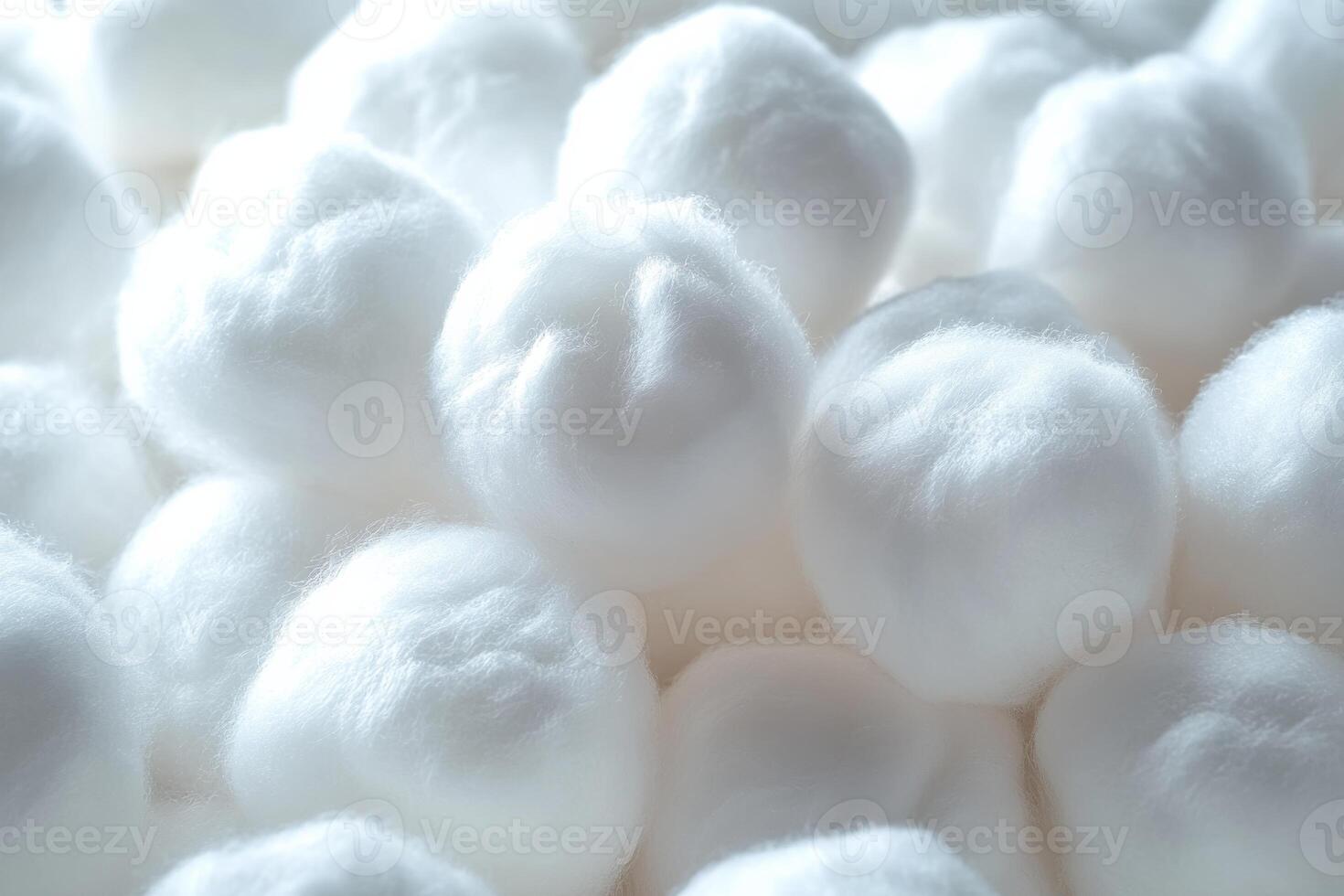 Close-up of fluffy cotton balls arranged neatly on a white surface creating a soft texture photo