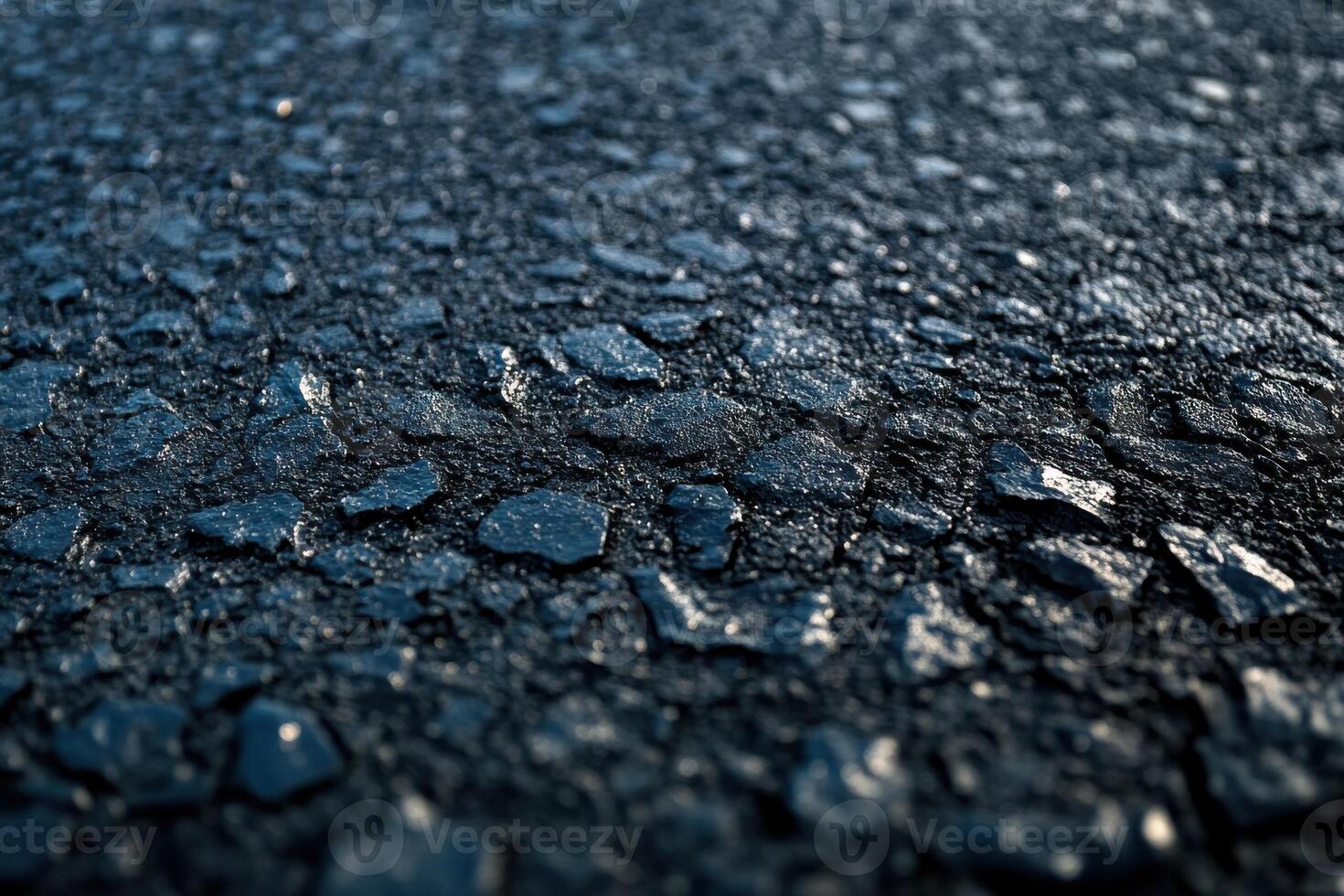 Close-up view of textured asphalt surface under natural light in the early morning hours photo