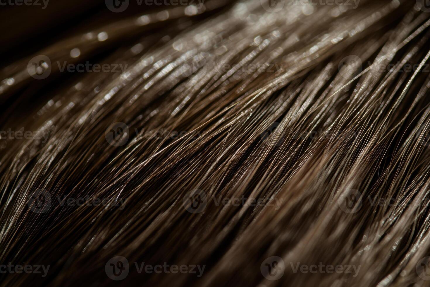 Close-up view of shiny brown hair strands illuminated in soft light photo
