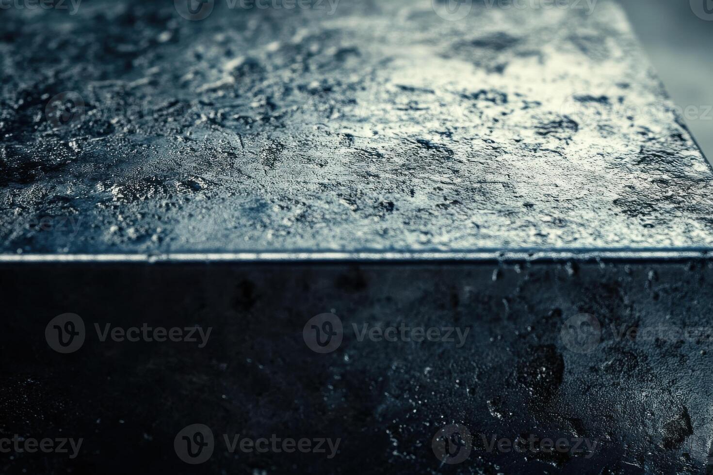 Close-up view of textured dark surface showcasing intricate details and shine in studio light photo