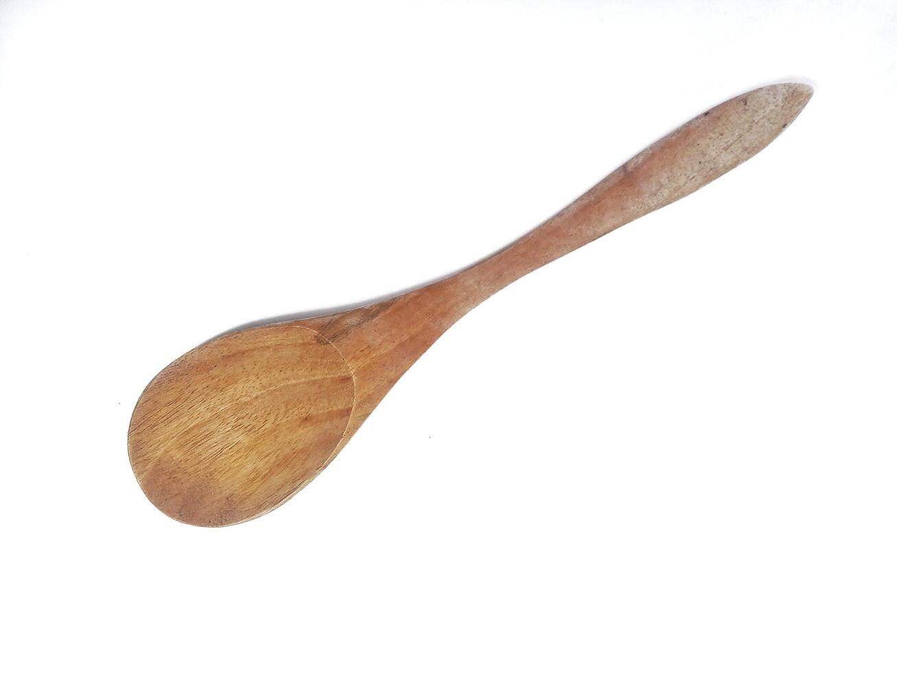 One empty brown wooden spoon isolated on white background with copy space area photo