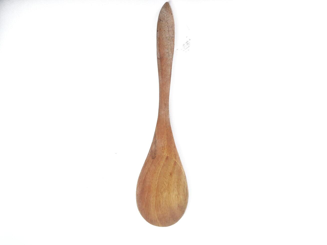 One empty brown wooden spoon isolated on white background with copy space area photo