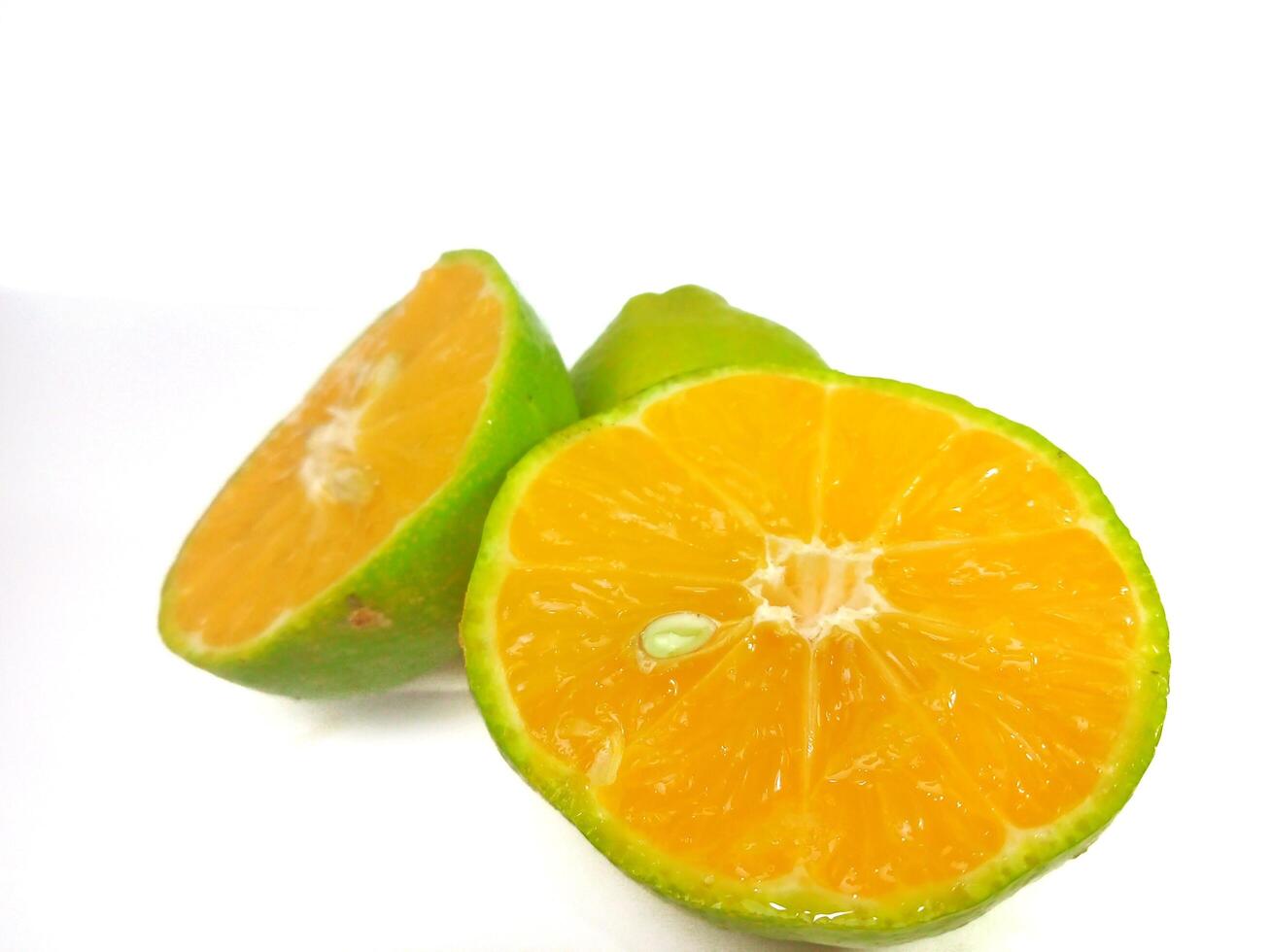 Lemon and slice isolated on white background. orange peel is green photo