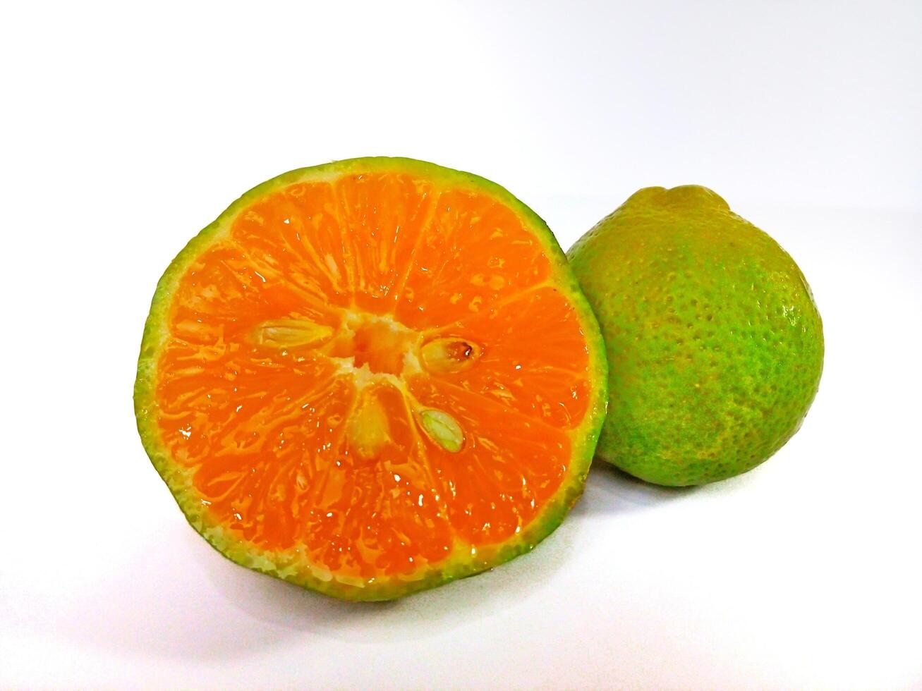 Lemon and slice isolated on white background. orange peel is green photo