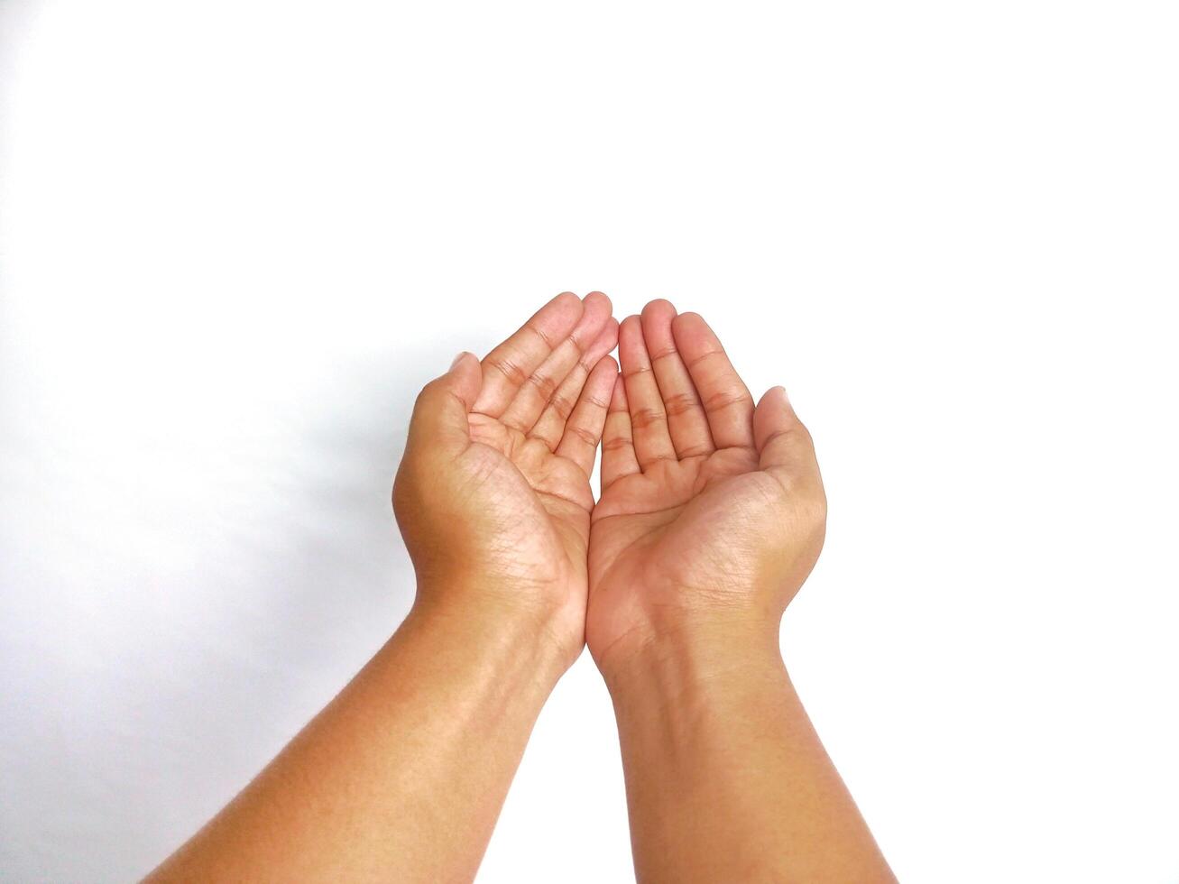 Religion. Man with open palms praying on white background, closeup photo