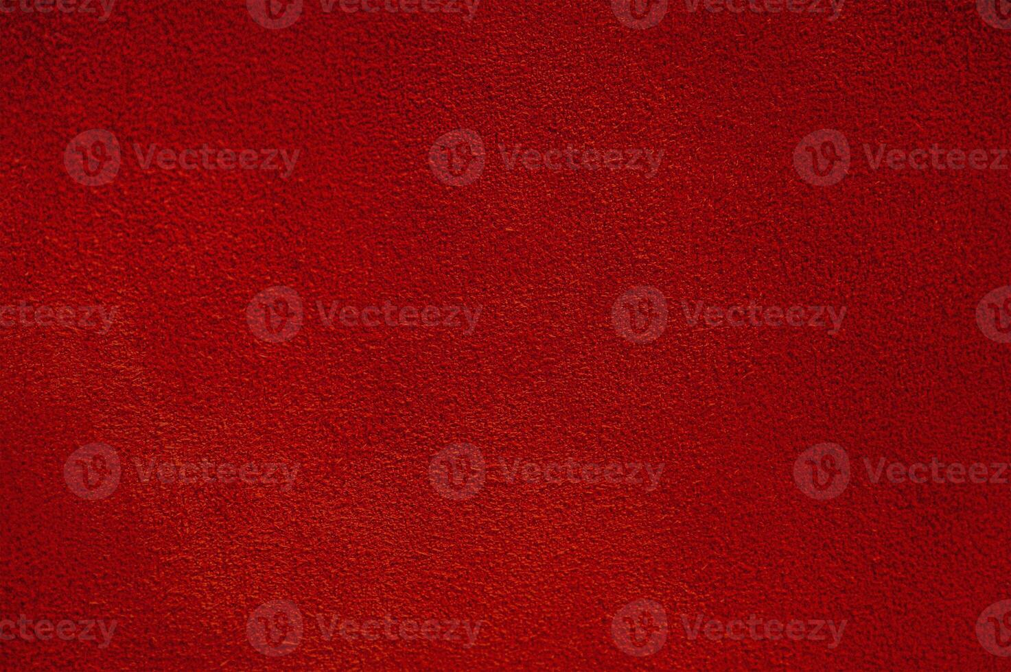 Red suede texture macro photo as background.