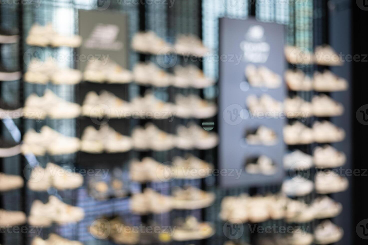 Abstract Blur Background of Row of shoes on display in shop. A view of a wall of shoes inside the store. Modern new stylish sneakers running shoes. photo