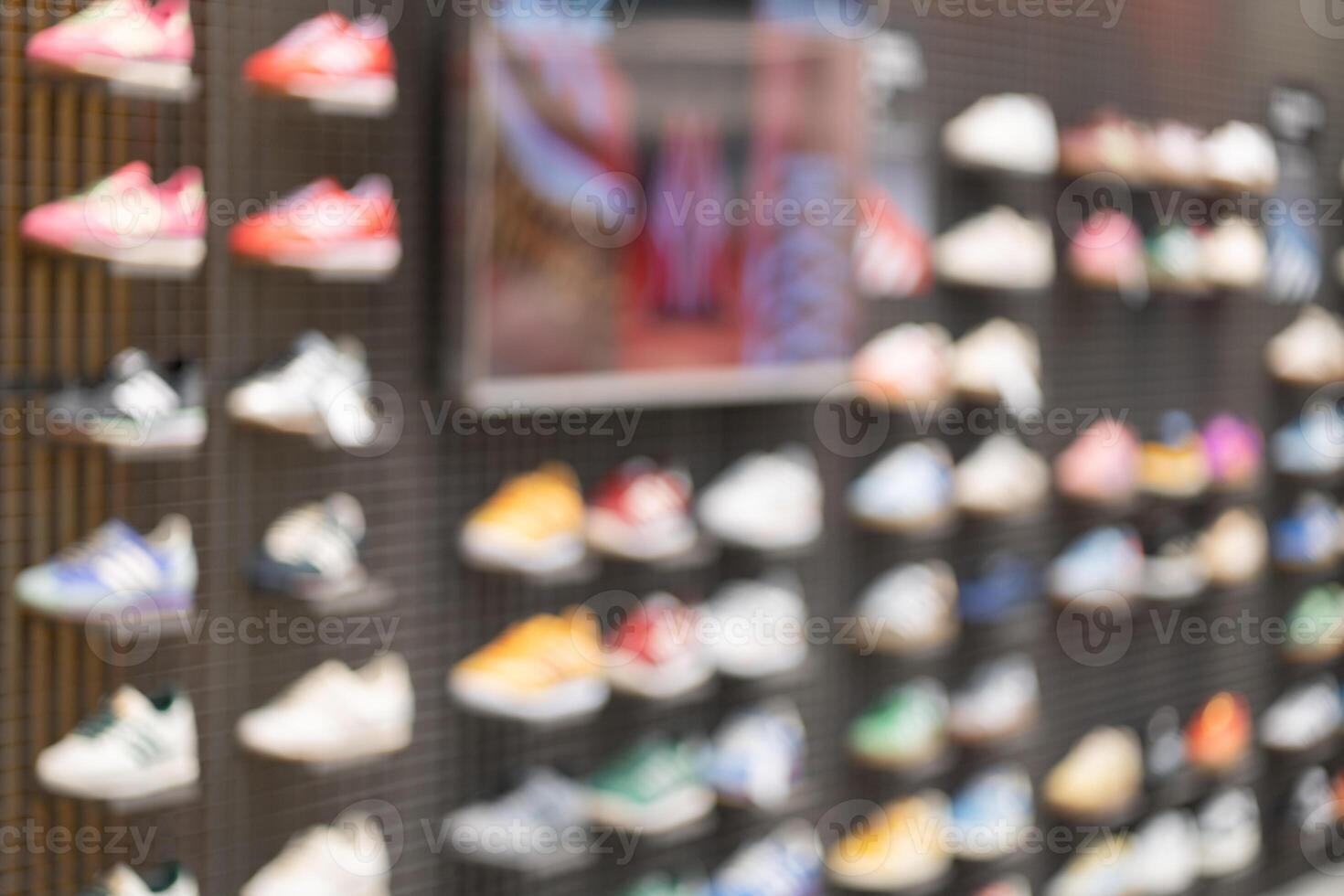 Abstract Blur Background of Row of shoes on display in shop. A view of a wall of shoes inside the store. Modern new stylish sneakers running shoes. photo