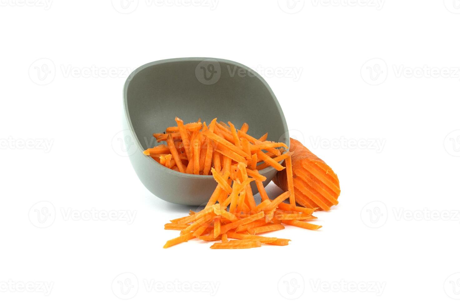 Freshly Grated Carrots in a Modern Gray Bowl on White Background photo