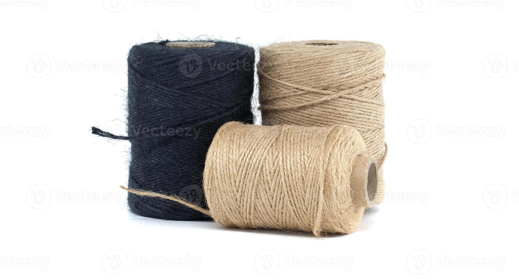 Collection of jute and twine spools on a white background, highlighting natural fiber materials photo