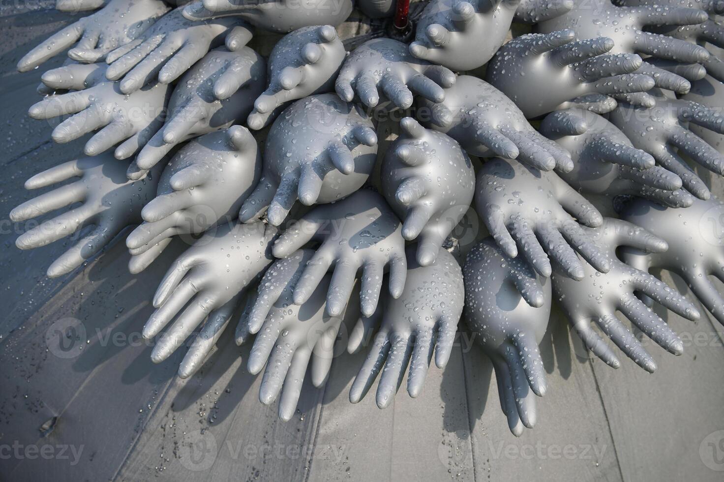 Abstract composition of inflated rubber gloves with water droplets creating unique artistic pattern photo