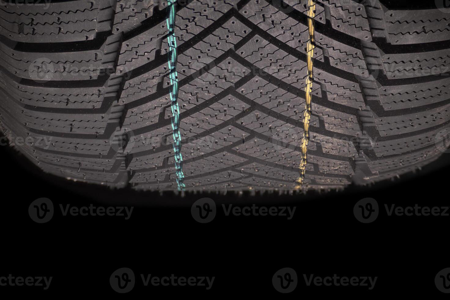 Car tire tread showcasing intricate pattern and colorful markings for enhanced grip and safety photo