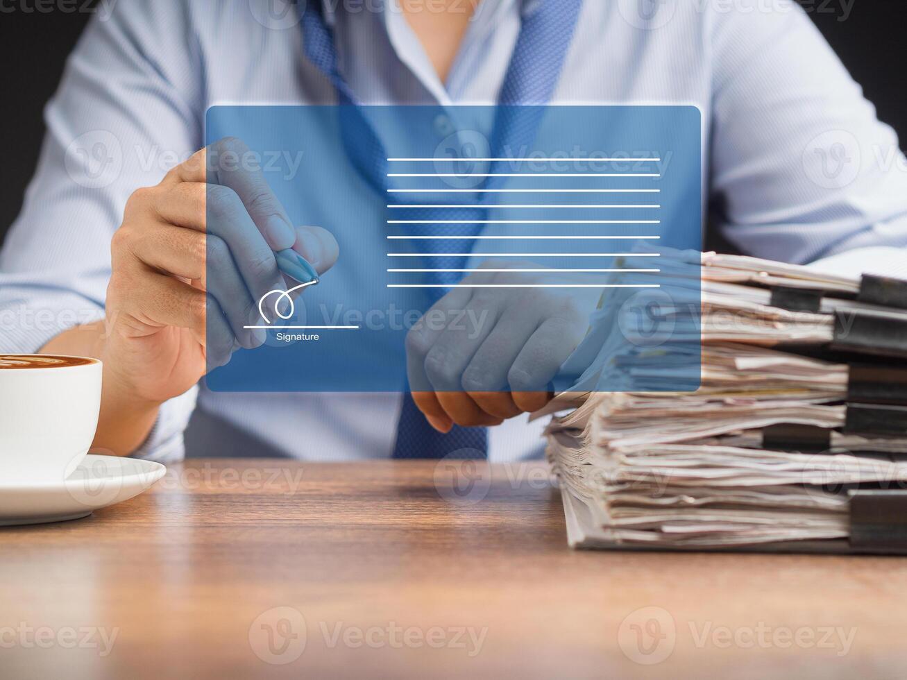 A businessman using a pen signing electronic documents on digital documents on a virtual screen photo