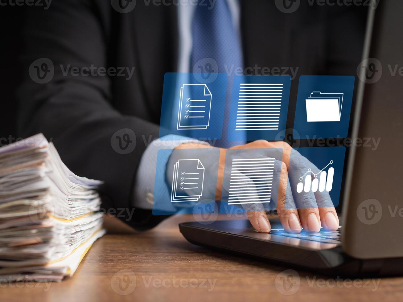 Businessman in a suit working at a laptop and digital documents with checkbox lists on virtual screen photo